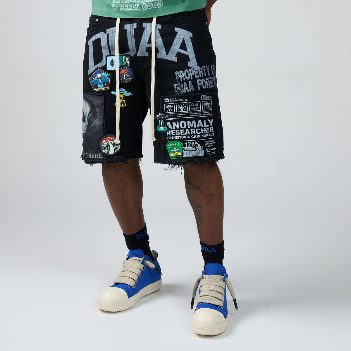 Men’s black graphic shorts with front patch text and stitched trim