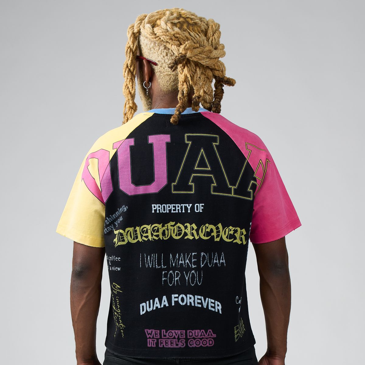 Men's tee back view: black panel with large UA graphic and multicolor sleeves