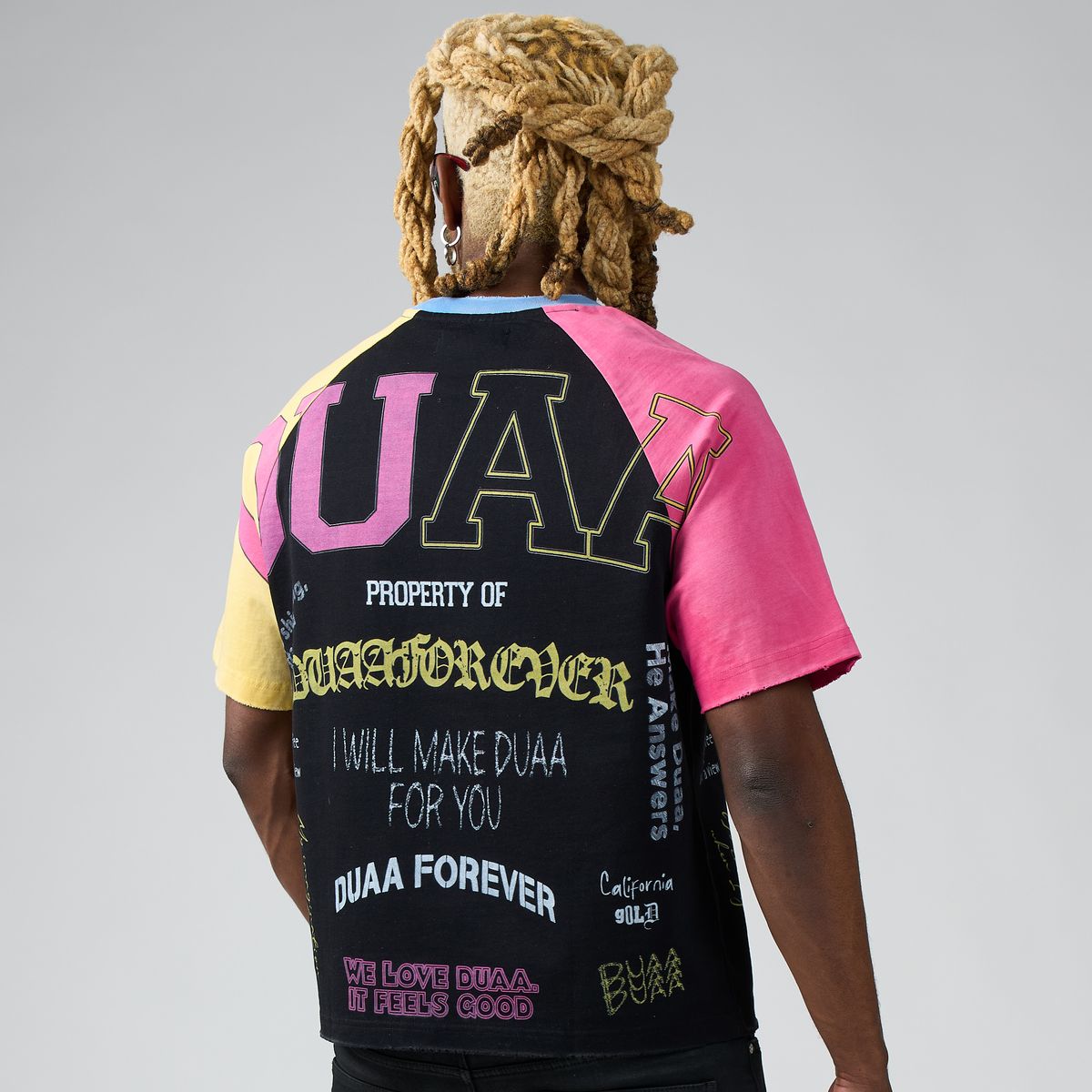 Men's tee back view with UA graphic and multicolor pink/yellow sleeves