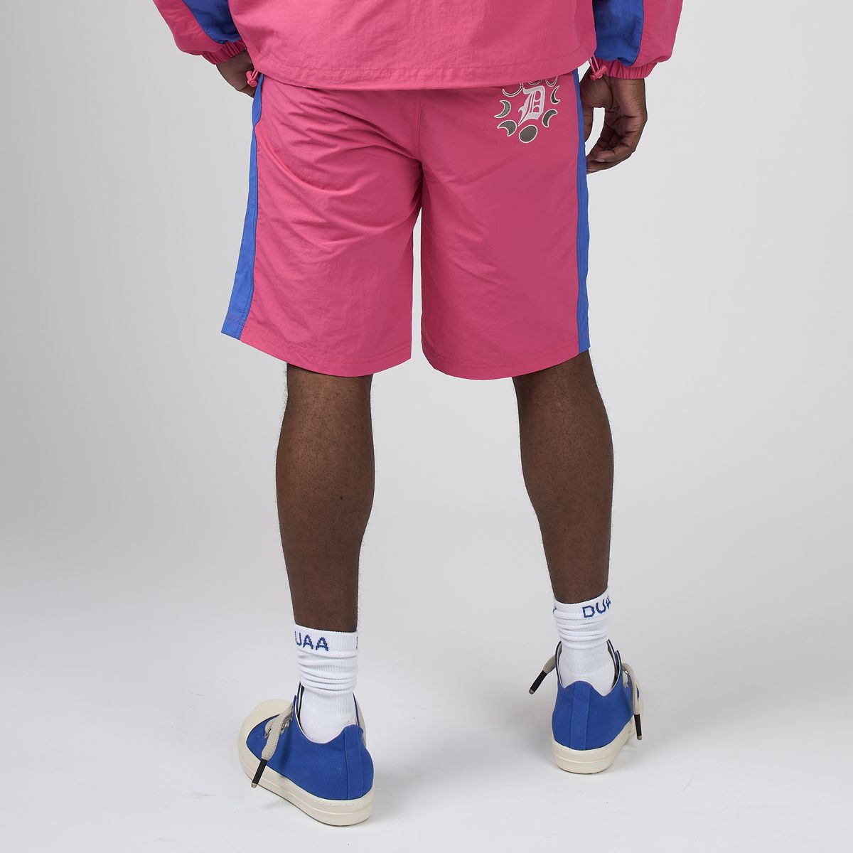 Men's pink sport shorts with blue side stripe and rear graphic, DUAA logo
