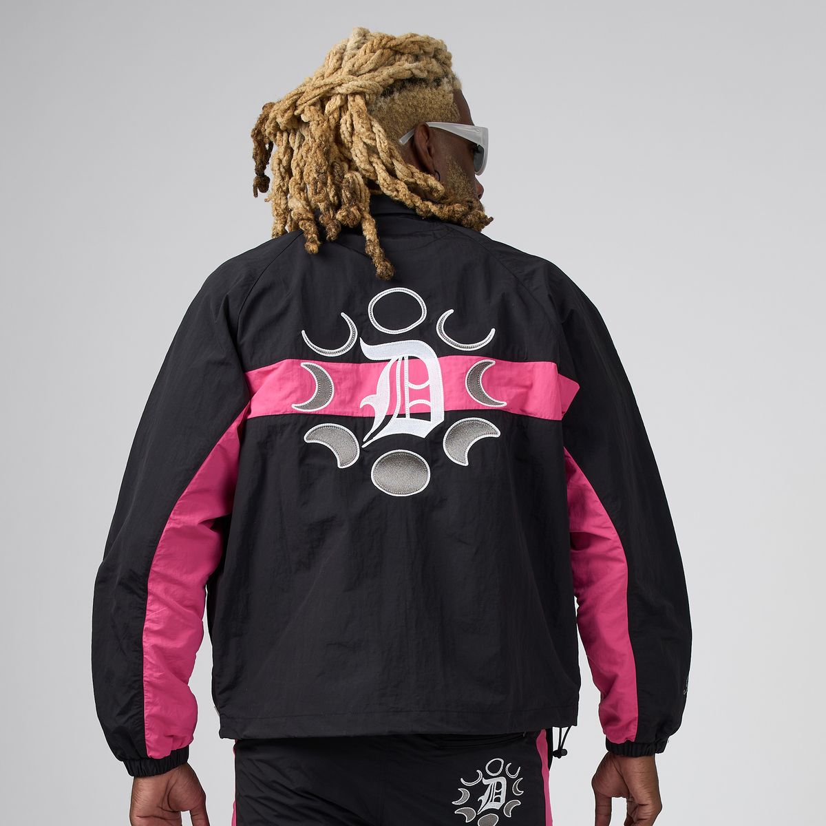 Men's cyber jacket back view, black with pink panels and graphic moon design