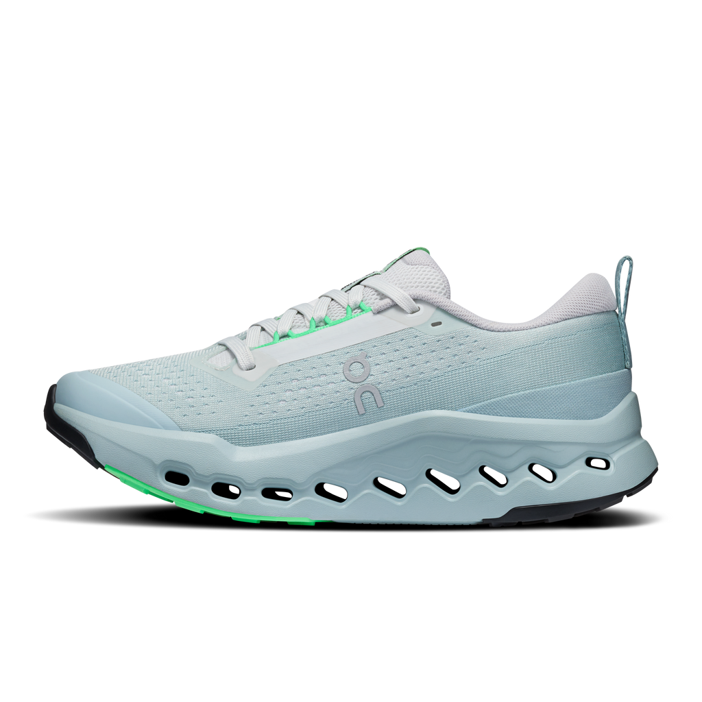 On women's trail running shoe, light blue mesh with white laces and green undersole edge