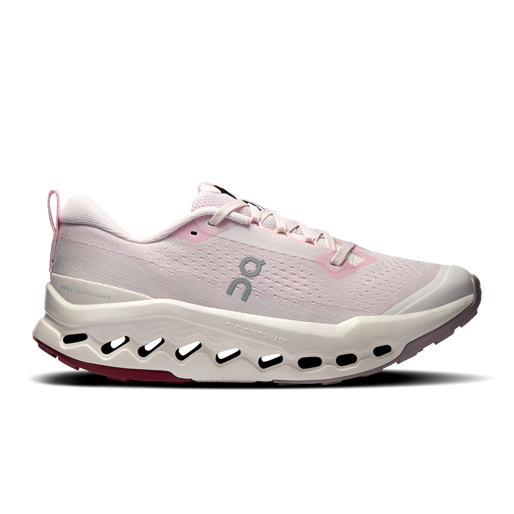 Light pink trail running shoes with lace-up mesh upper and white cloud sole pods