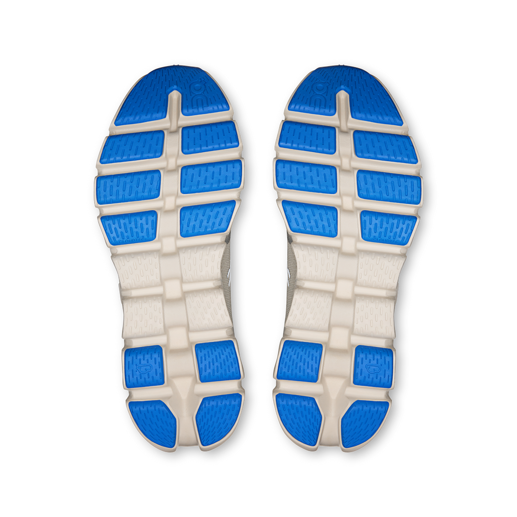 Shoe outsole tread with blue rubber pods and white traction blocks