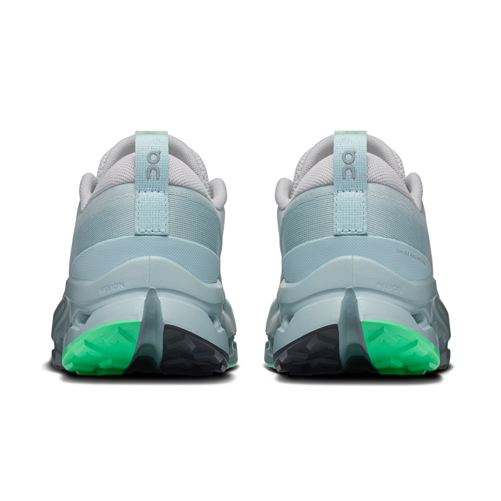 On women's trail shoes, heel view, light blue back with green outsole and pull tab
