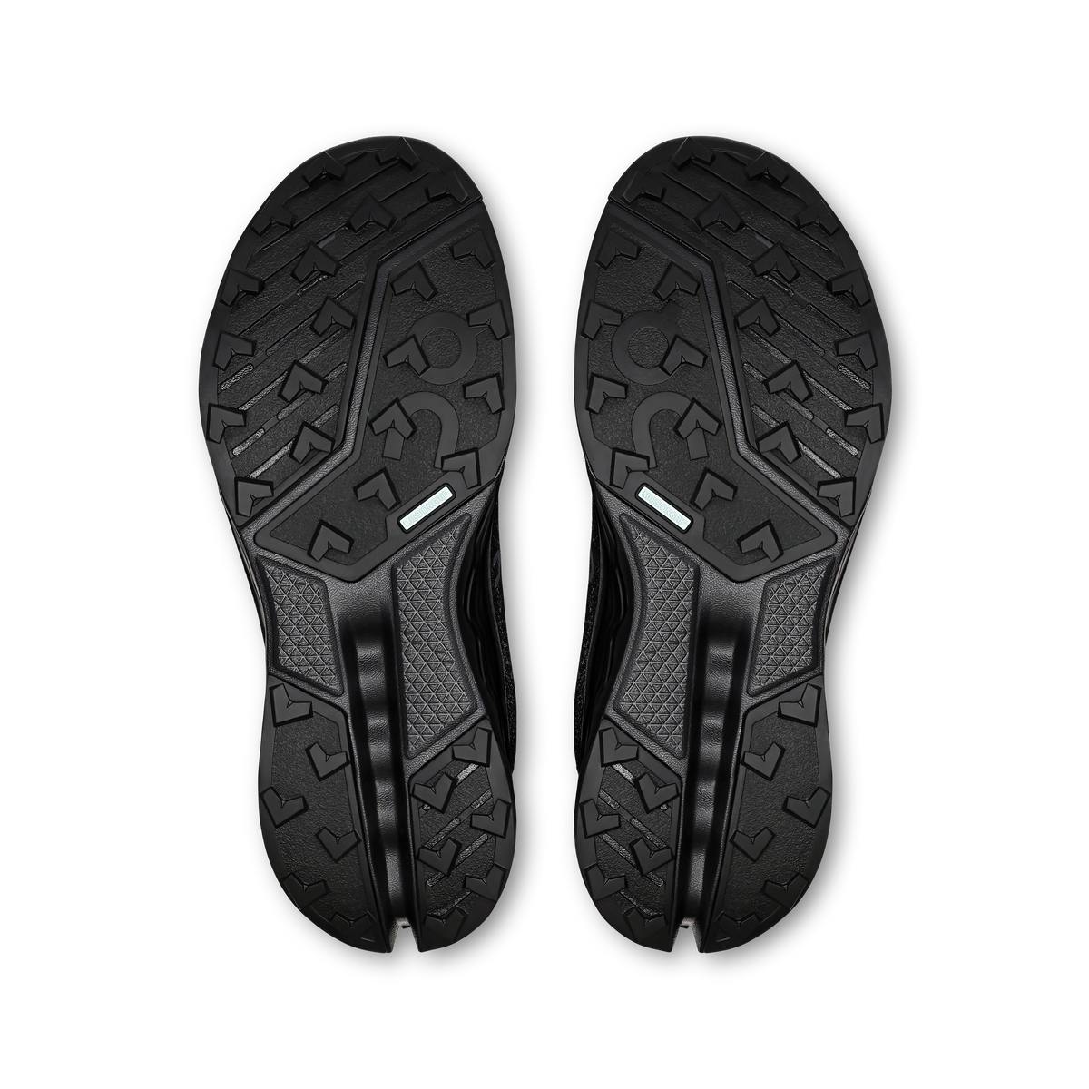 Pair of black shoe outsoles with rugged tread and On branding