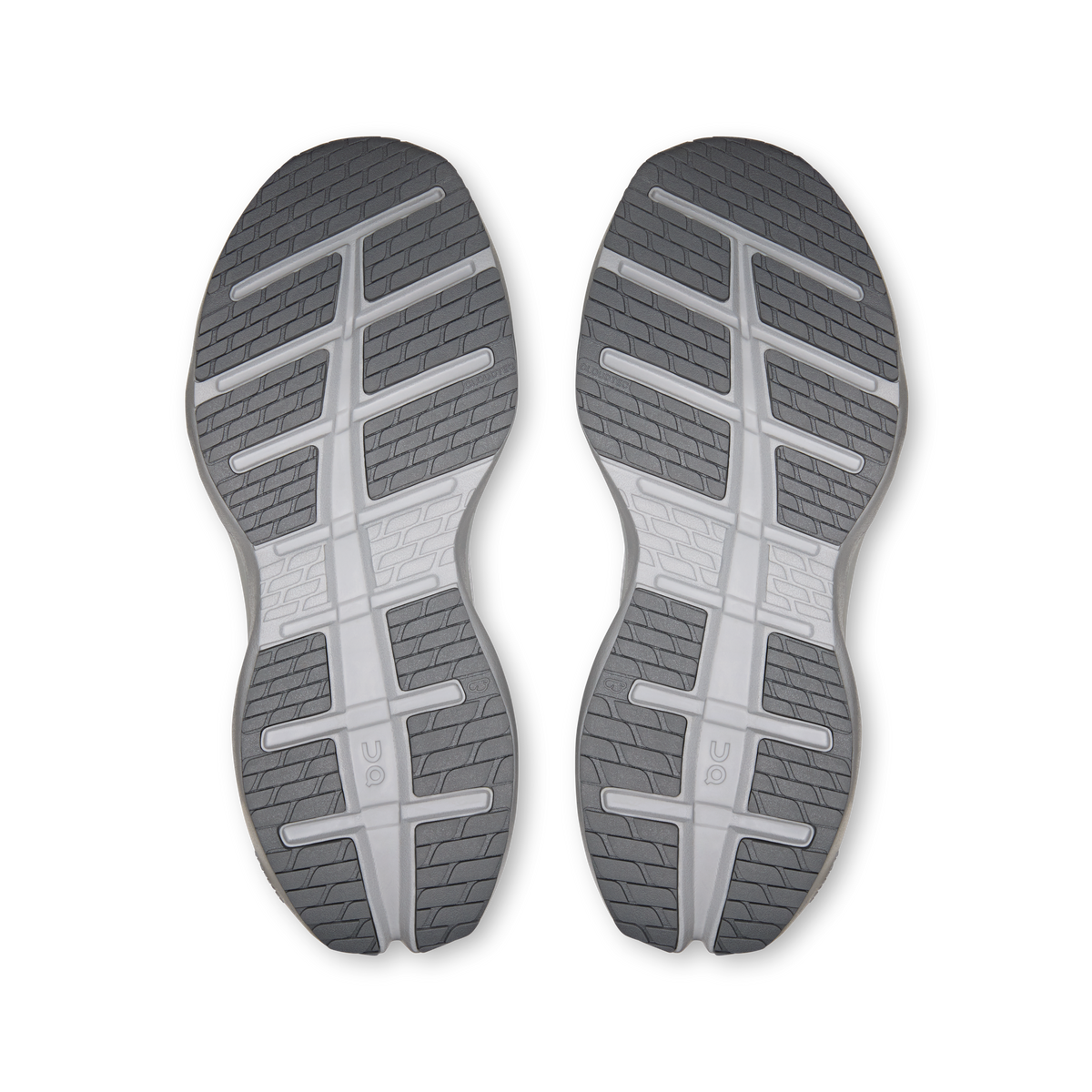 Pair of shoe outsoles with grippy tread and segmented cushioning channels