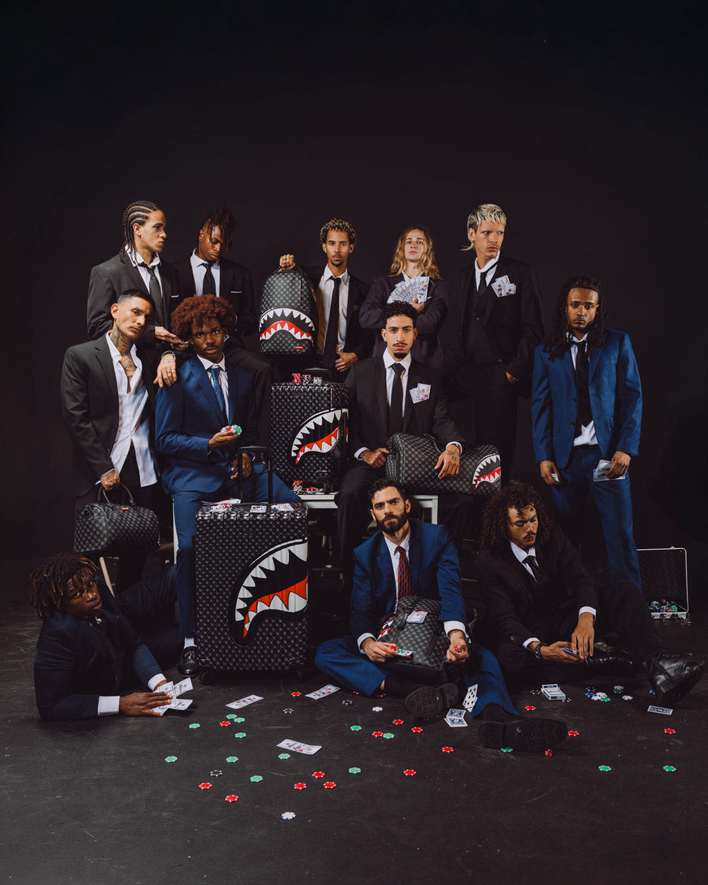 Sprayground shark-mouth backpack bag on display among group on stage