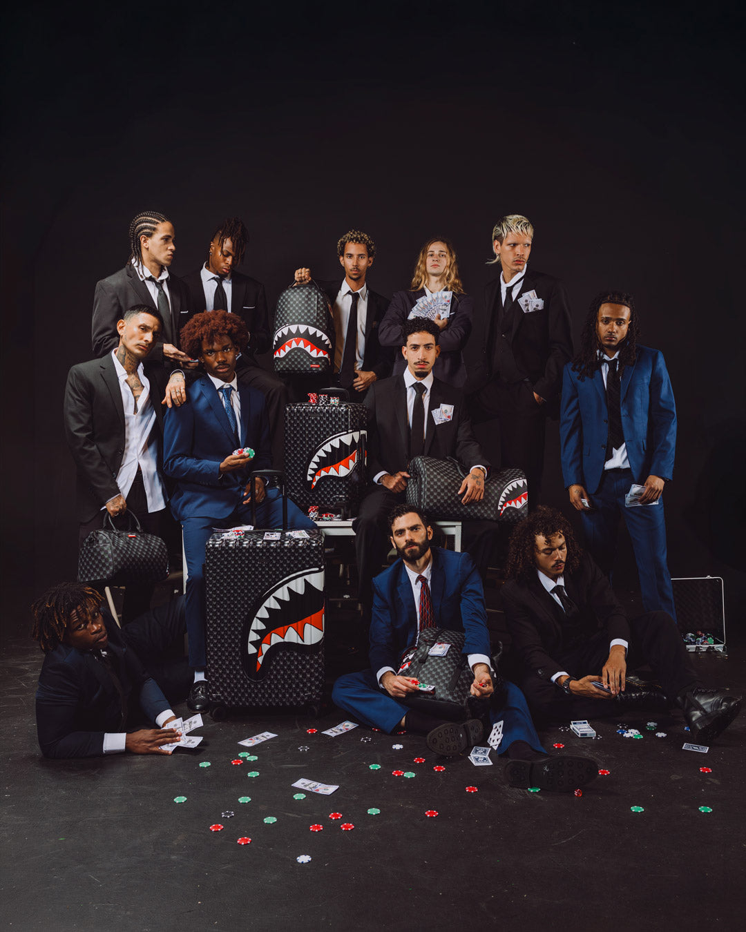 Sprayground shark-mouth backpack bag on display among group on stage