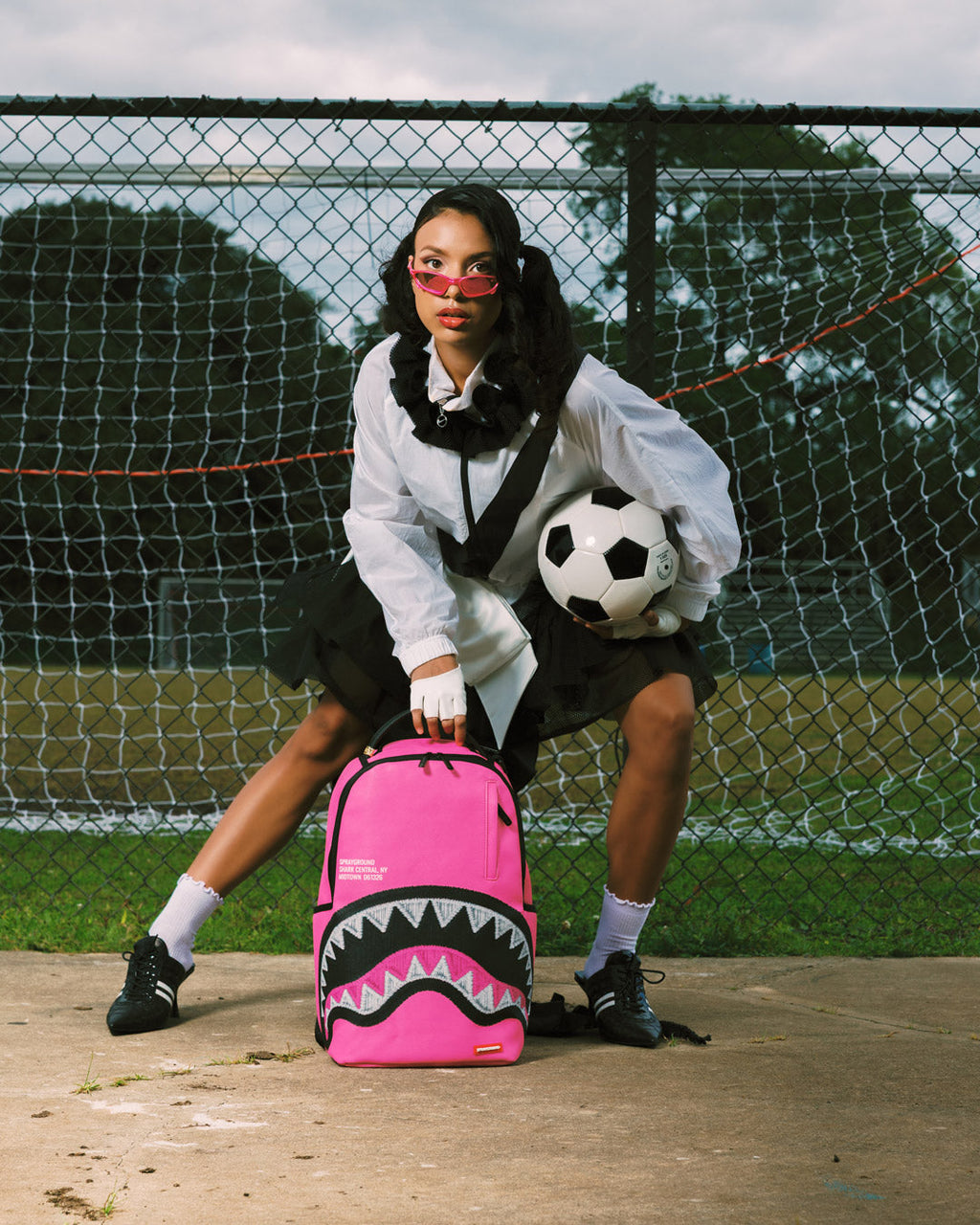 Pink mini backpack with black zigzag shark graphic front