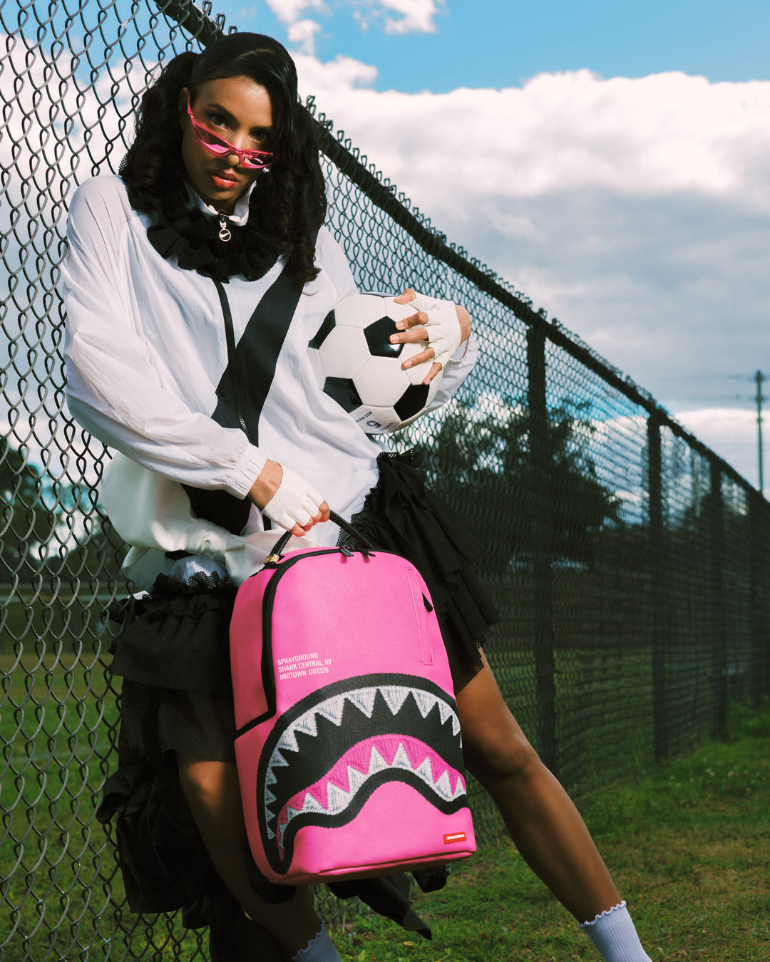 Pink mini backpack with black shark graphic panel and shoulder straps