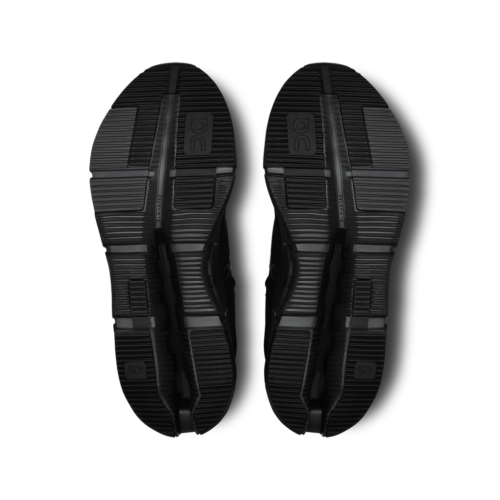 Pair of black shoe outsoles with tread pattern and CloudTec pod cutouts