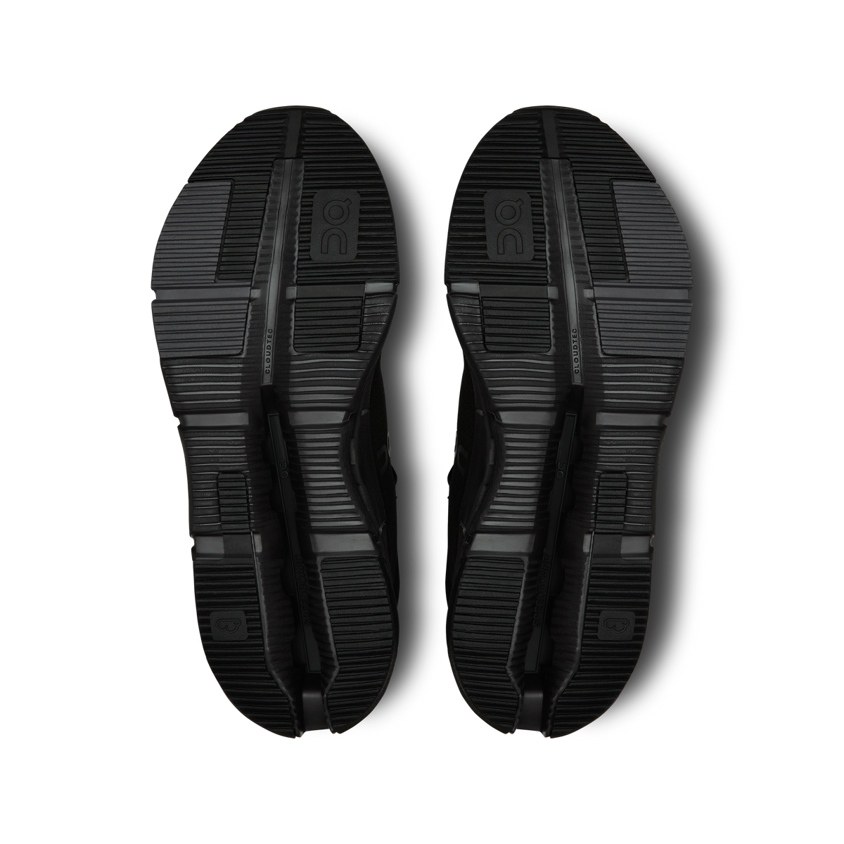 Pair of black shoe outsoles with tread pattern and CloudTec pod cutouts