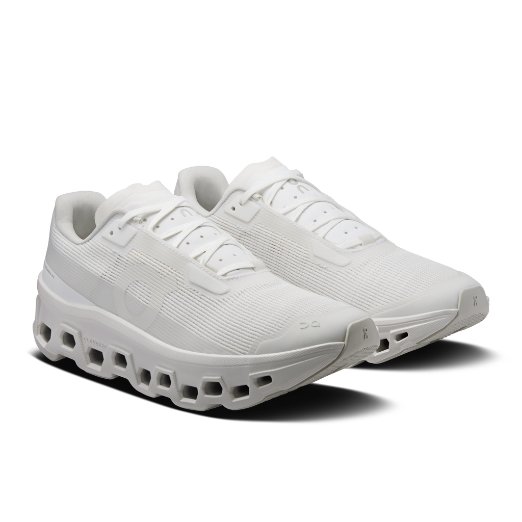 Women's white running shoes in side view with cushioned midsole and laces