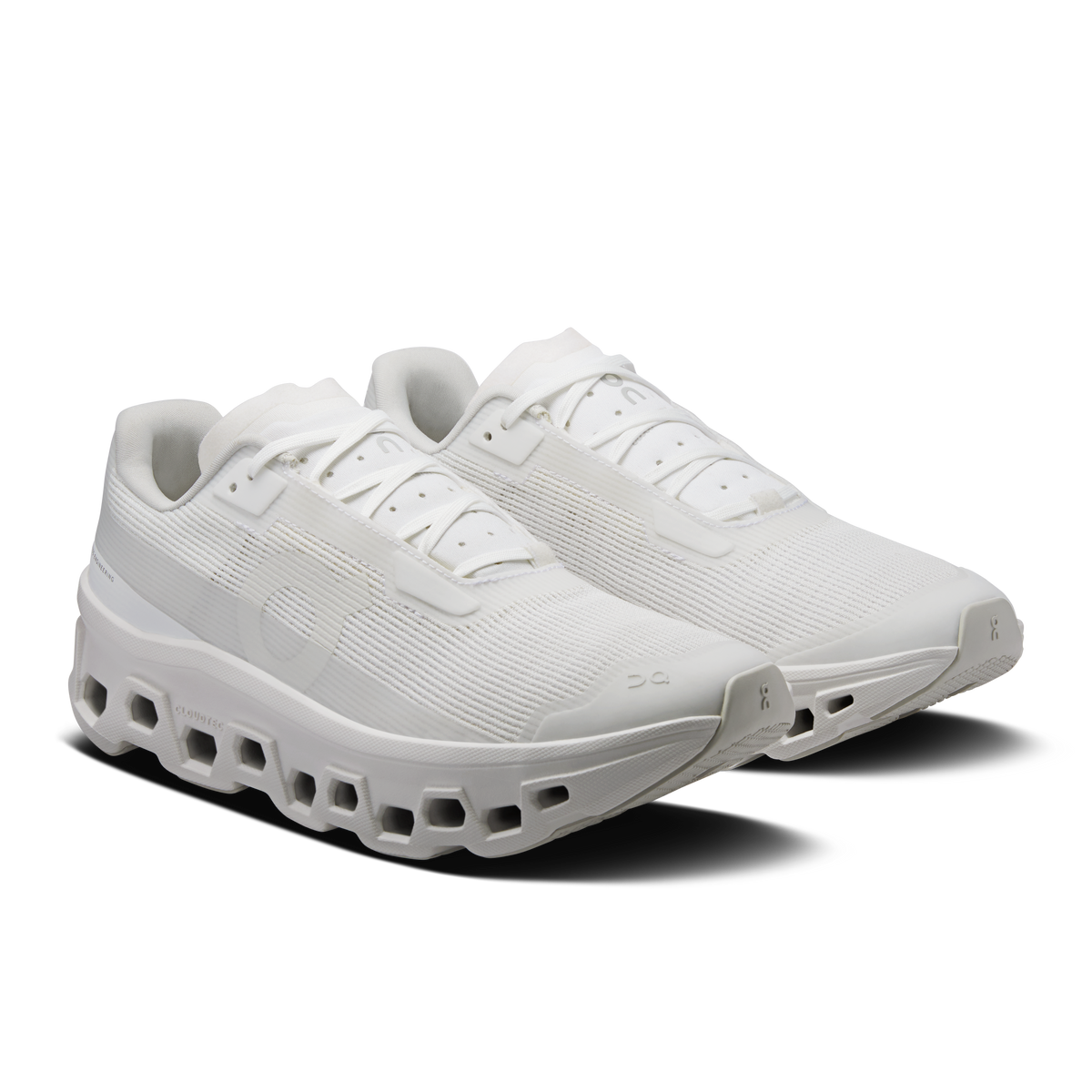 Women's white running shoes in side view with cushioned midsole and laces