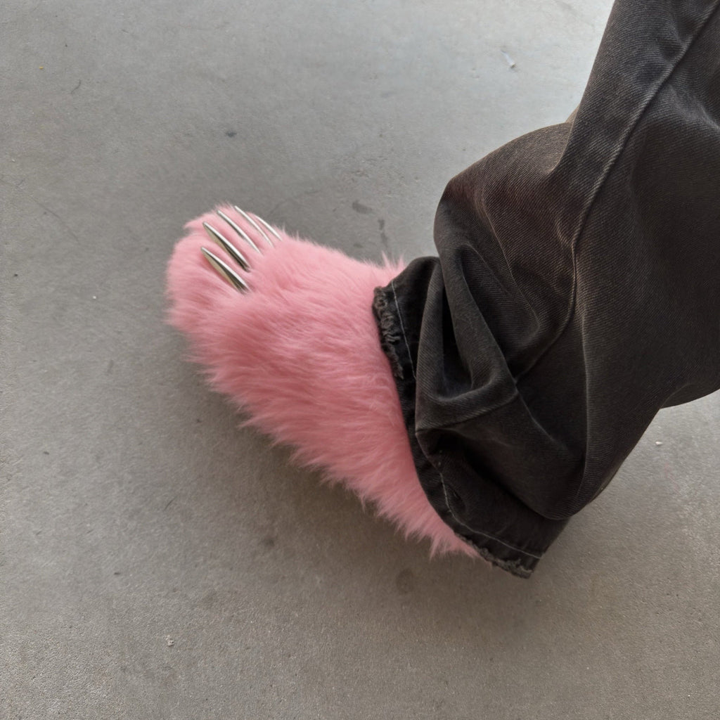 Pink bear claw mule on dark pants, faux-fur upper and open claw toes