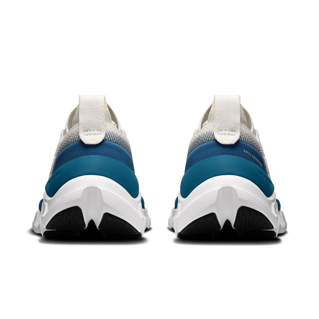 Women’s heel view: white collar with blue heel panel and thick cushioned outsole