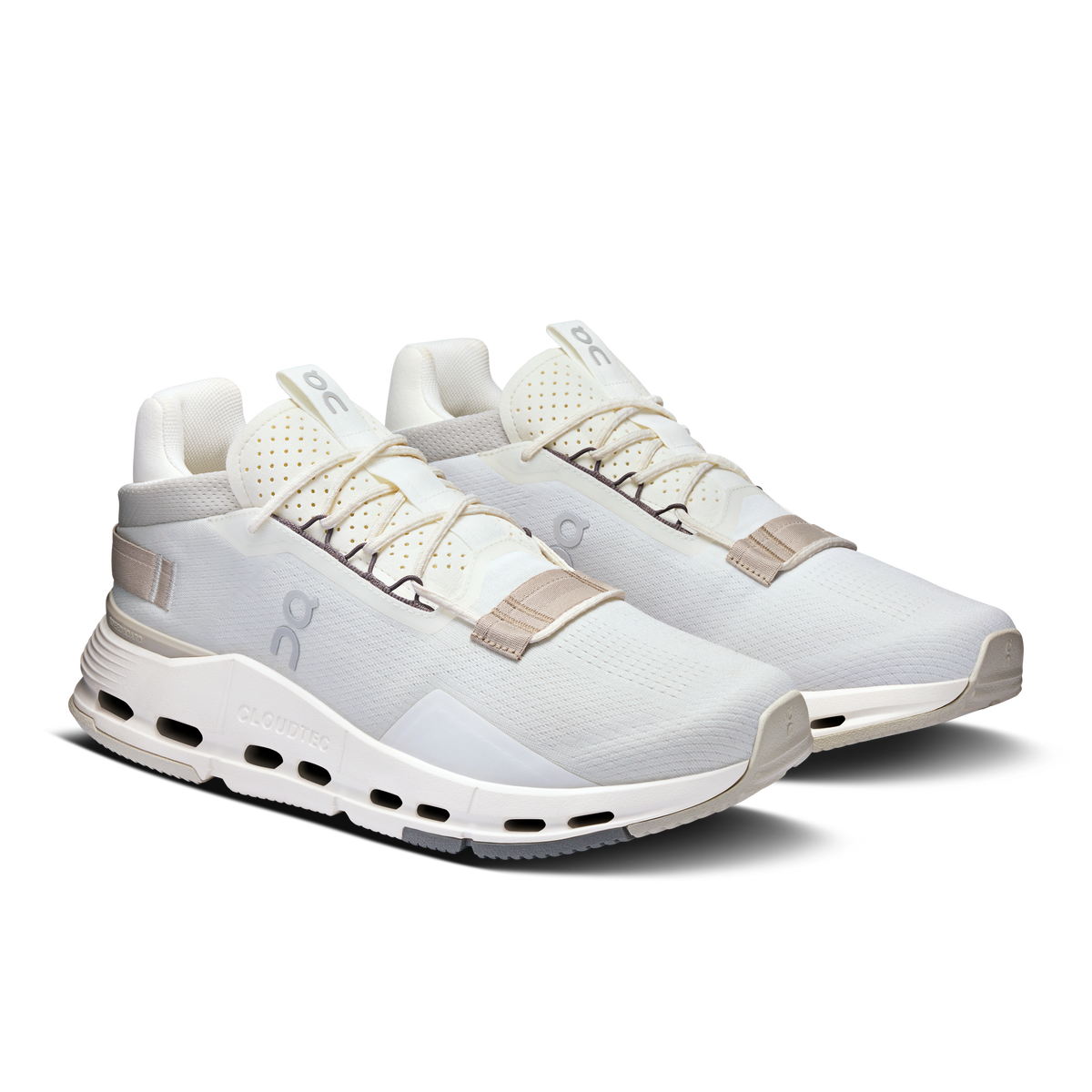 Pair of white lace-up running shoes with sand heel tabs and CloudTec outsole