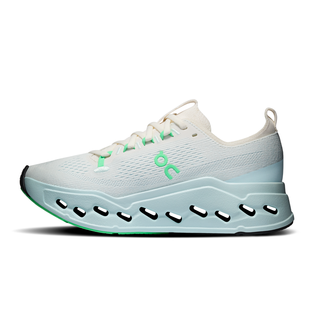 Women’s running shoes, ivory top with green logo and light-blue cushioned platform