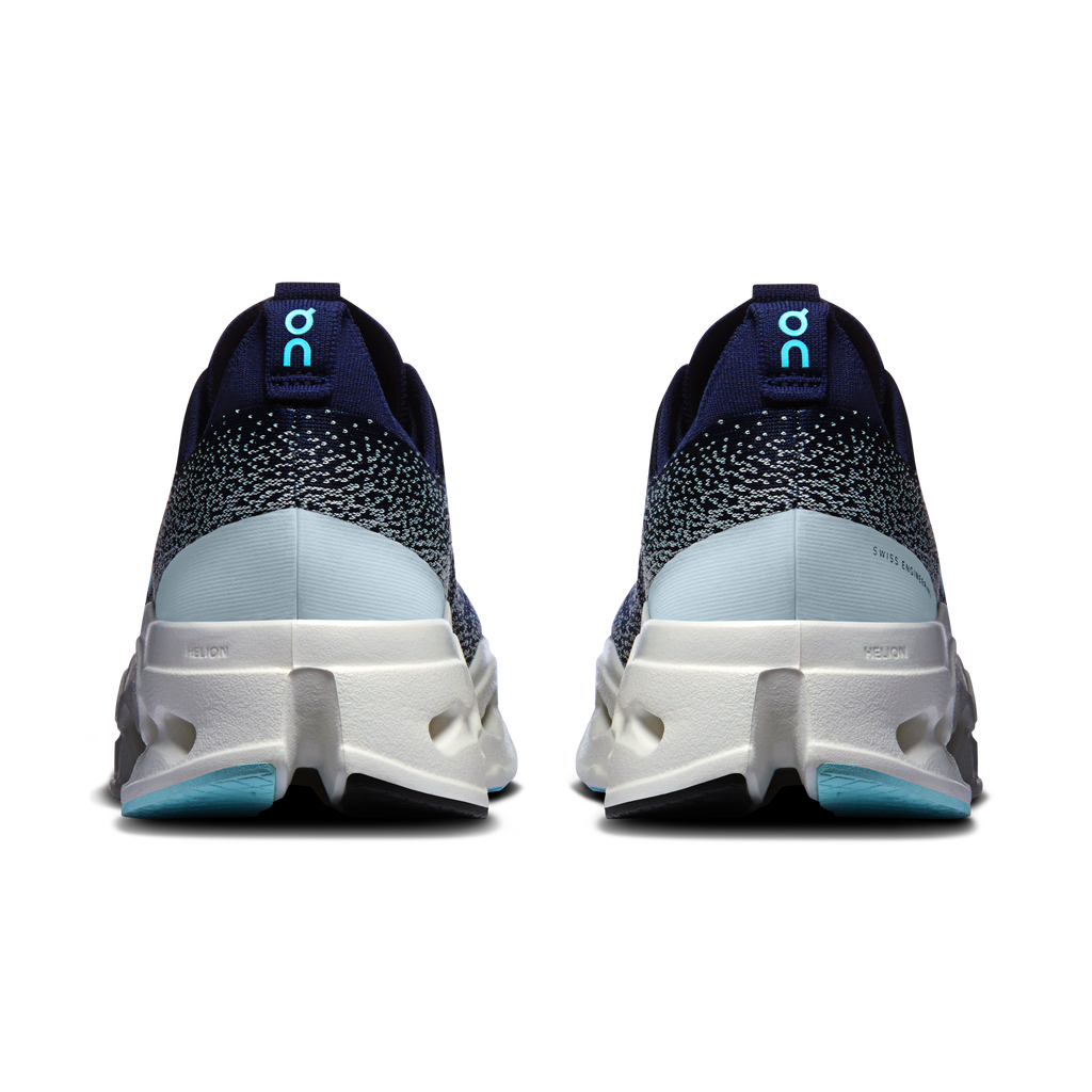 Men's running shoes heel view, dark navy knit with white foam midsole and blue logo