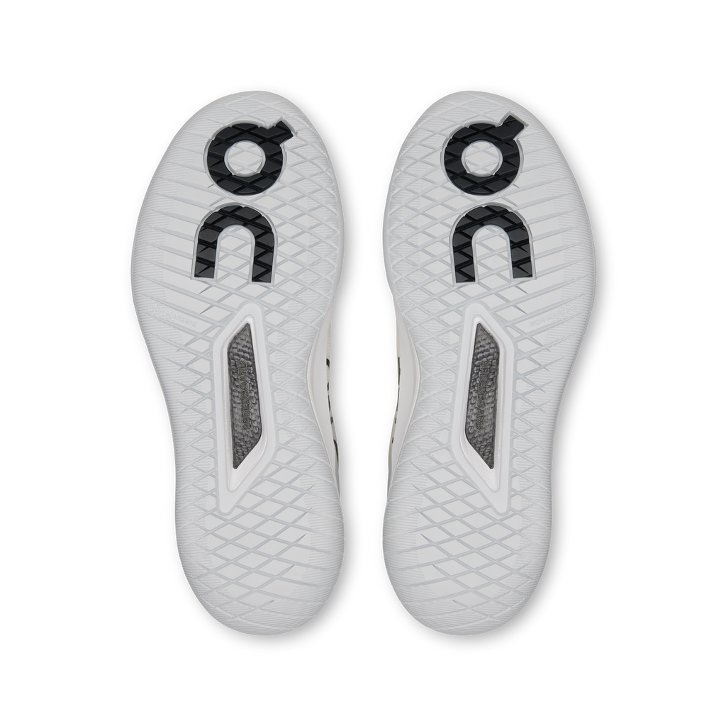 White shoe outsoles with textured tread and gray reinforced panels