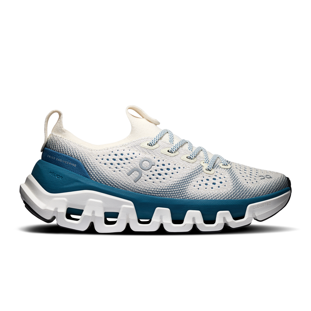 Women’s running shoes with white mesh upper, blue side panels, cushioned tread sole