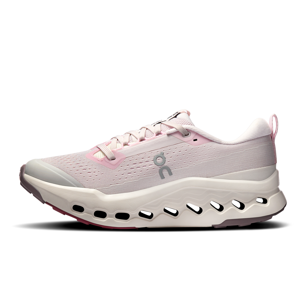 Light pink trail running shoe with lace-up mesh upper and white sole with cutout pods