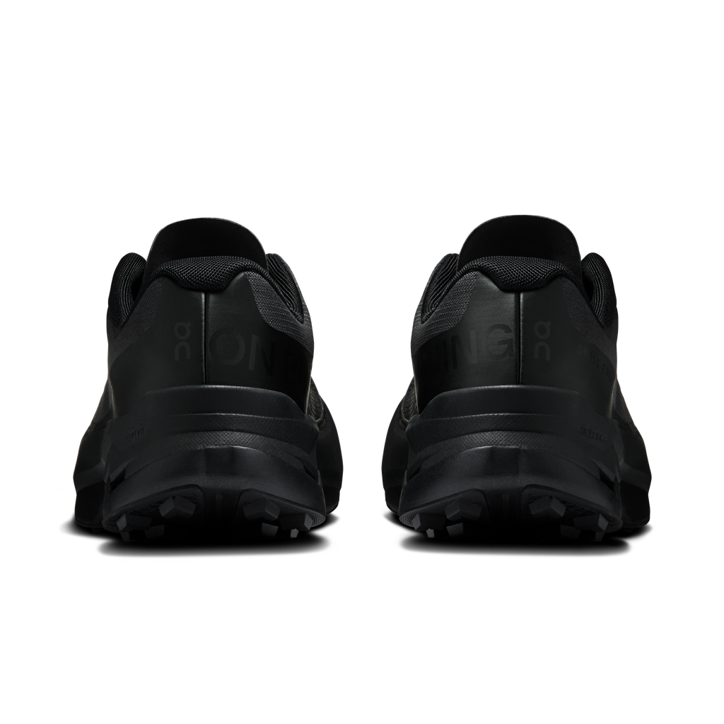 Women's black running shoes, rear view with heel cushioning and grippy tread