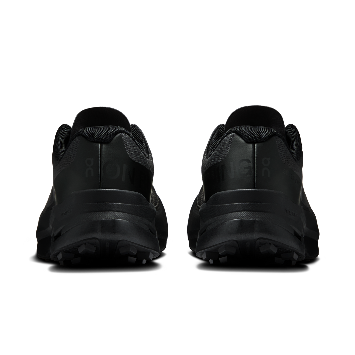 Women's black running shoes, rear view with heel cushioning and grippy tread