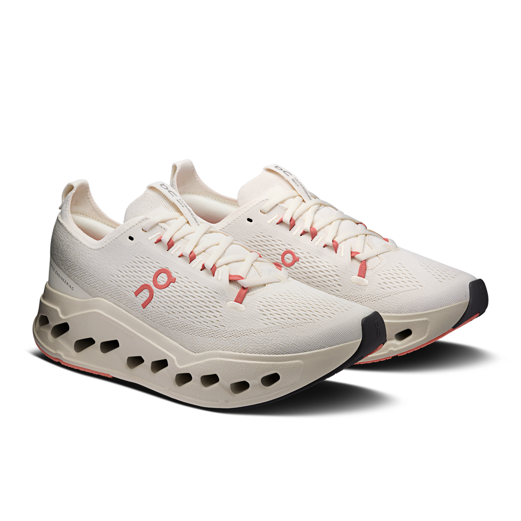 On Cloudsurfer Max running shoes, ivory upper with red lace accents and perforated sole