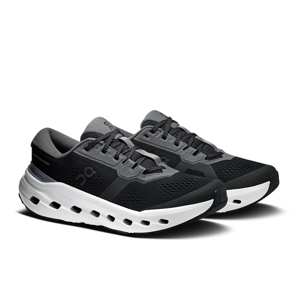 Black lace-up running shoes with white midsole cutouts and gray heel accents.