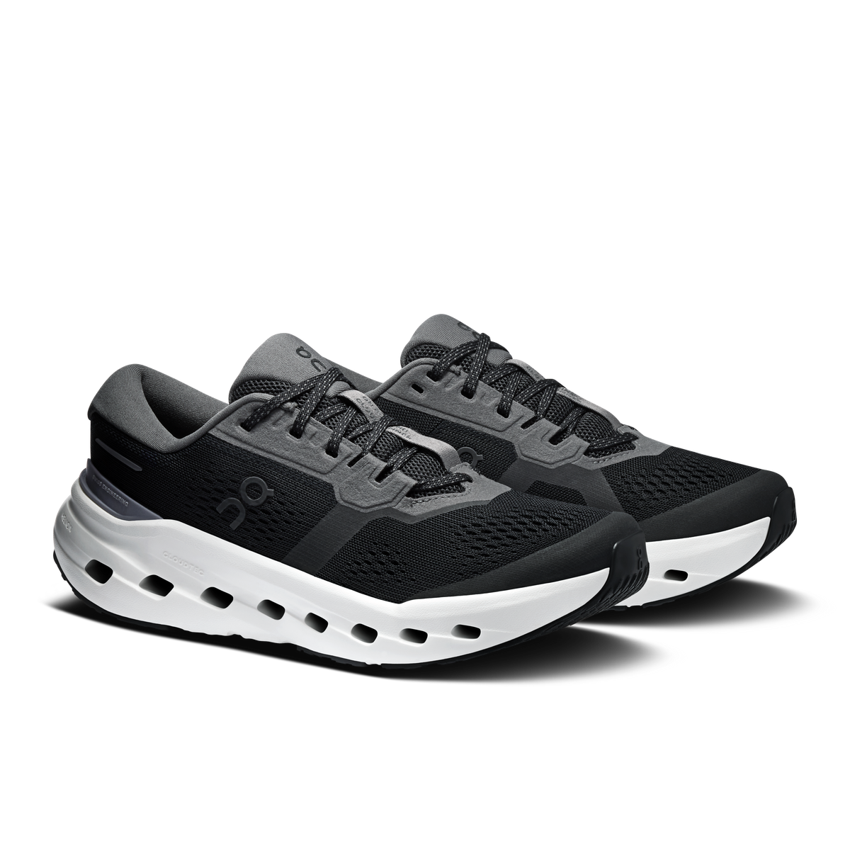 Black lace-up running shoes with white midsole cutouts and gray heel accents.