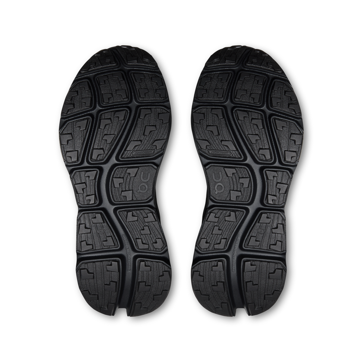 Pair of black shoe outsoles with deep tread and patterned traction blocks