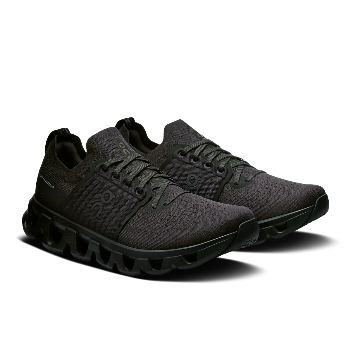 Men's lace-up running shoes in dark black with textured knit panels