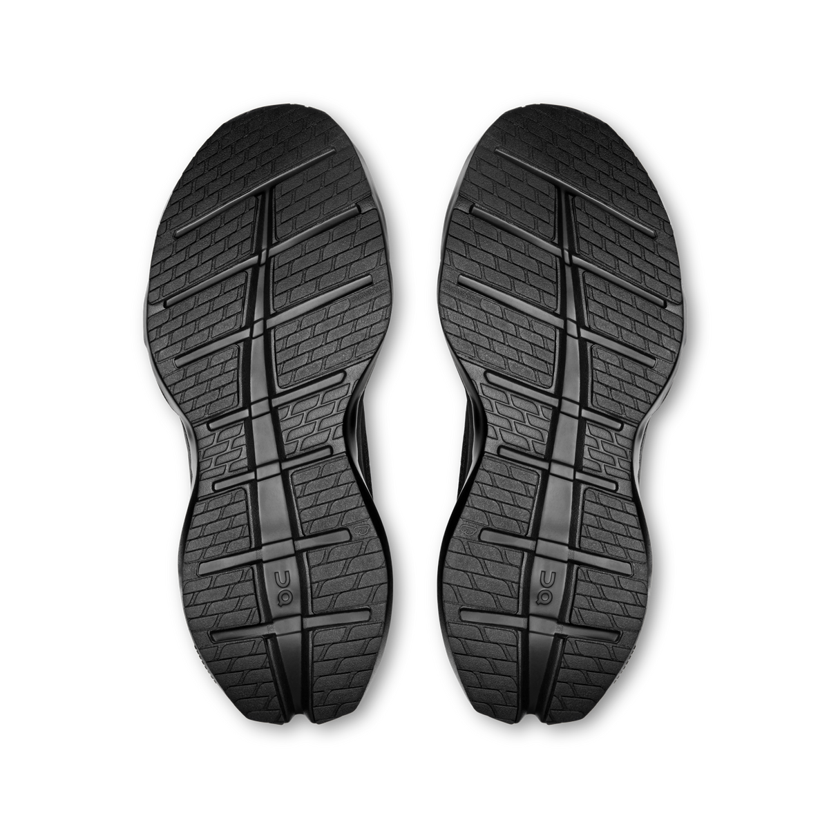 Pair of black shoe outsoles with deep tread pattern