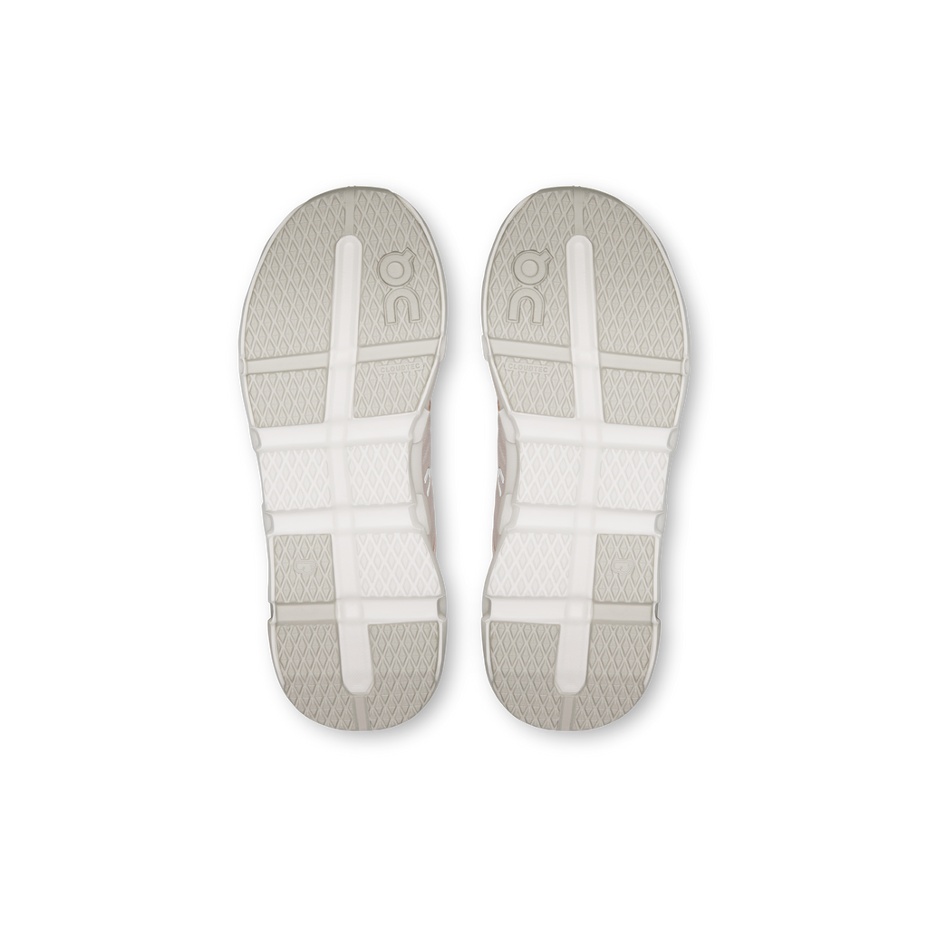 Pair of kids' running shoe outsoles, textured white tread with pale accents