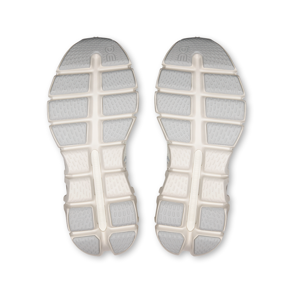 Pair of shoe outsoles with white rubber tread, center cross and segmented lugs