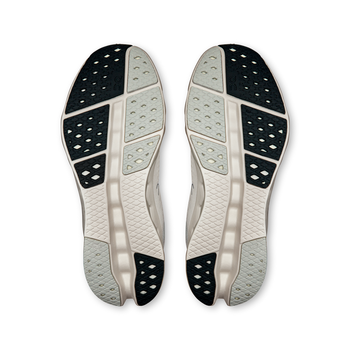 Bottom view of white outsole with dark tread sections and cushioning pods