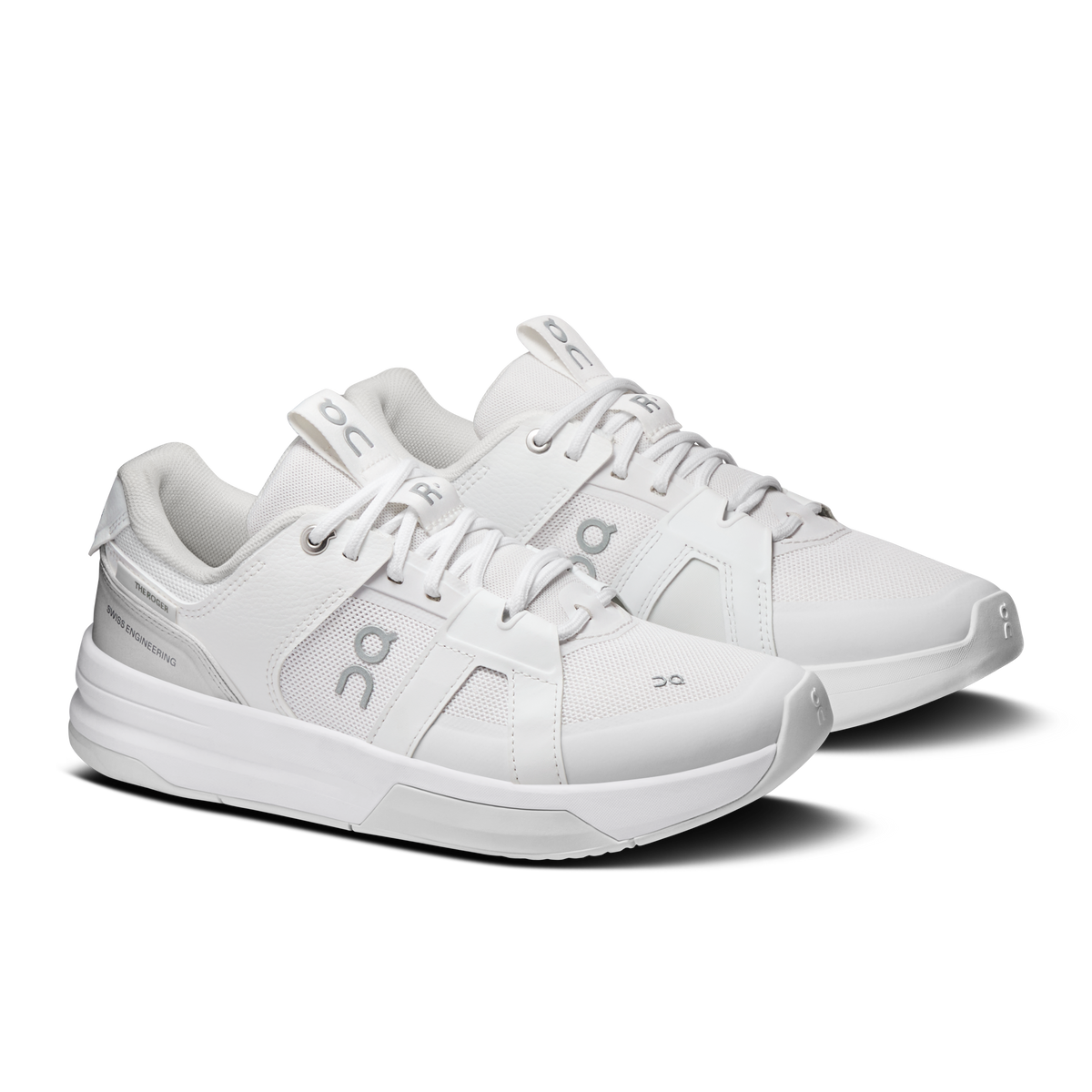 On women's running shoes in white with lace-up top, logo panels, and cushioned sole