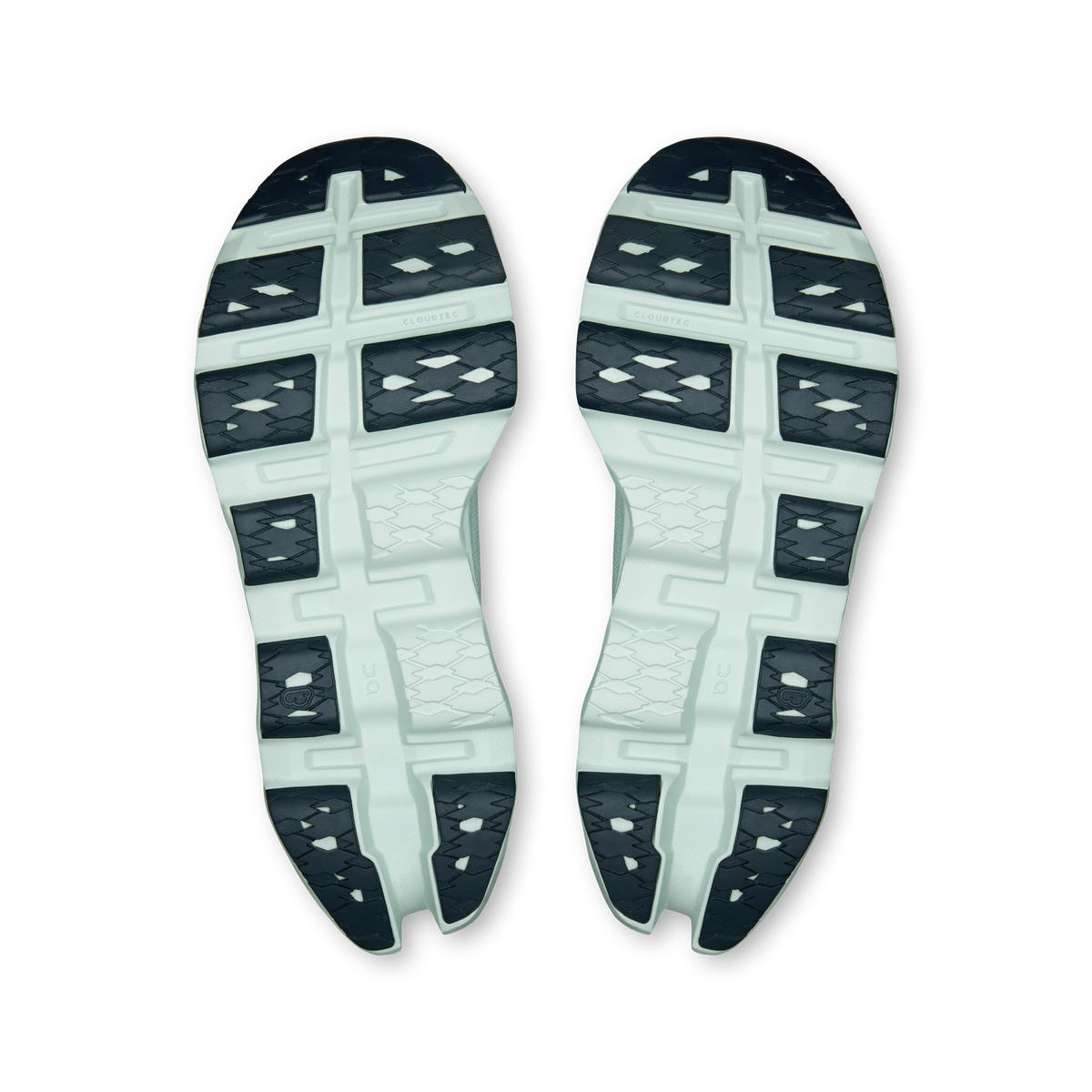 On running shoe outsoles, white with blue-gray traction blocks and grid pattern.