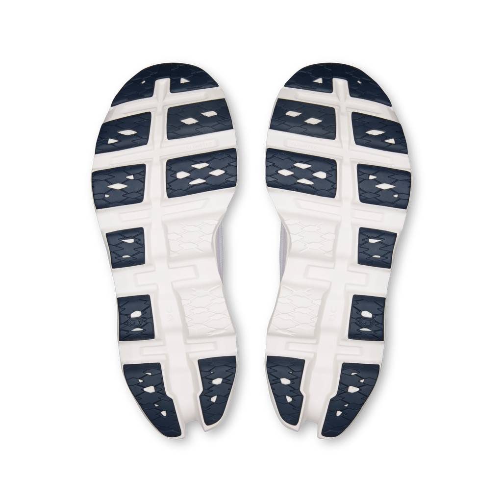 Pair of running shoe outsoles, white tread with dark blue geometric pattern