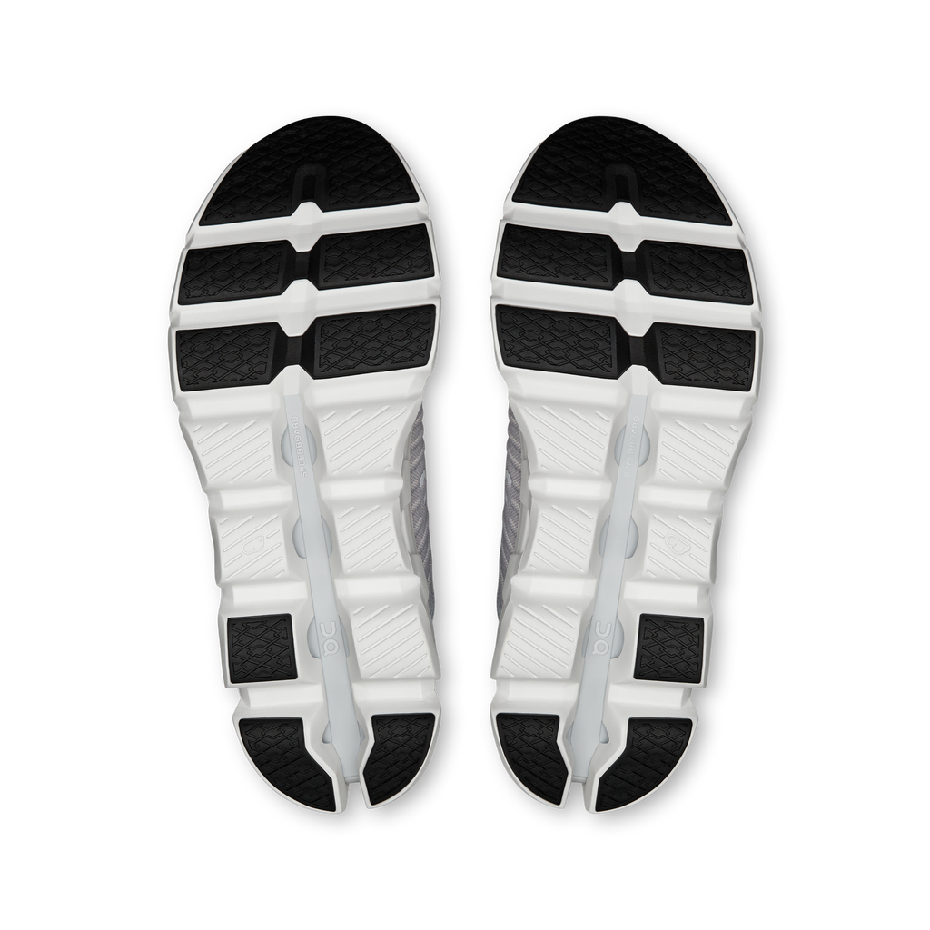 Pair of gray-and-white shoe outsoles with textured tread pattern