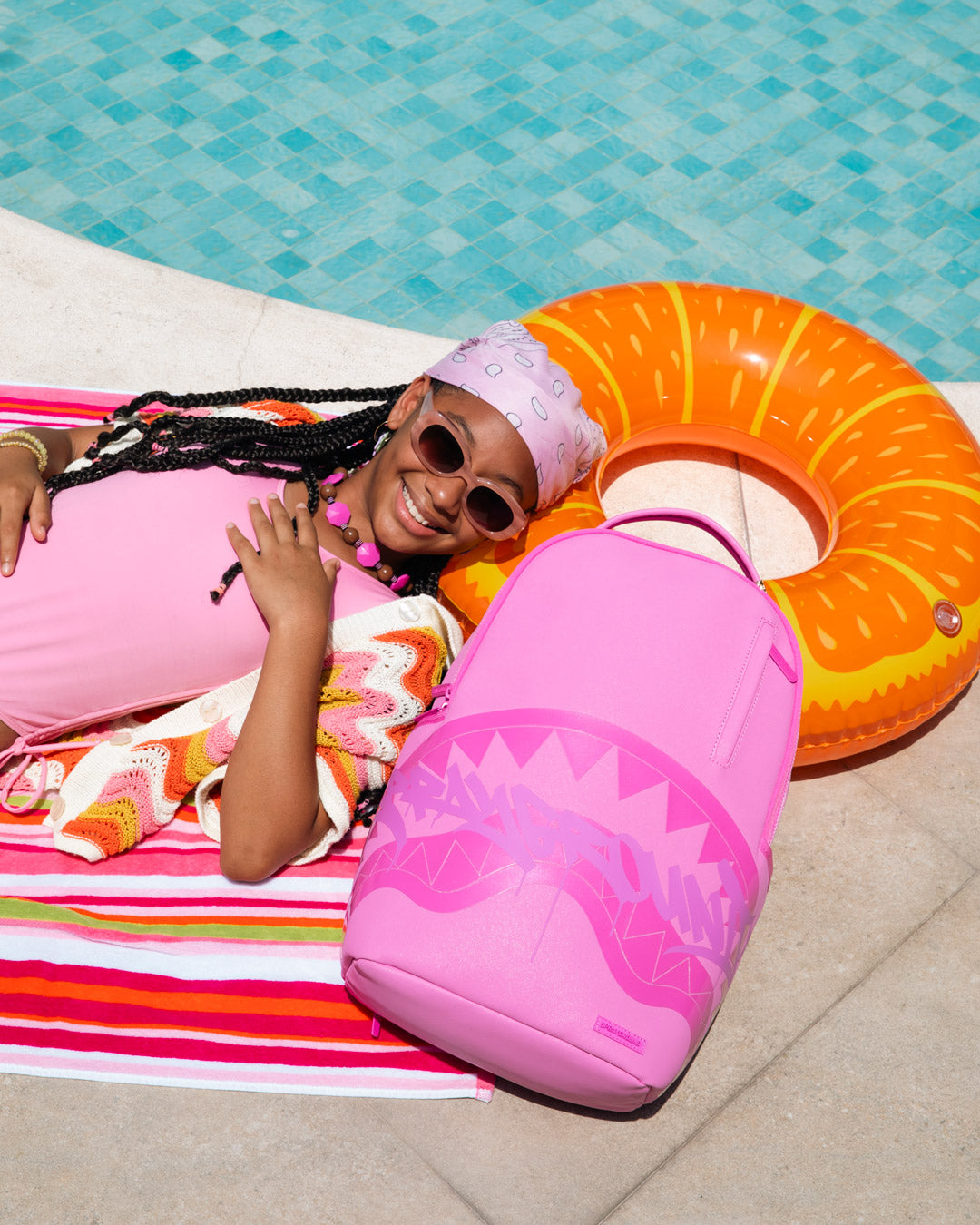 Pink shark-graphic backpack bag with curved silhouette, front wave print, zip pocket