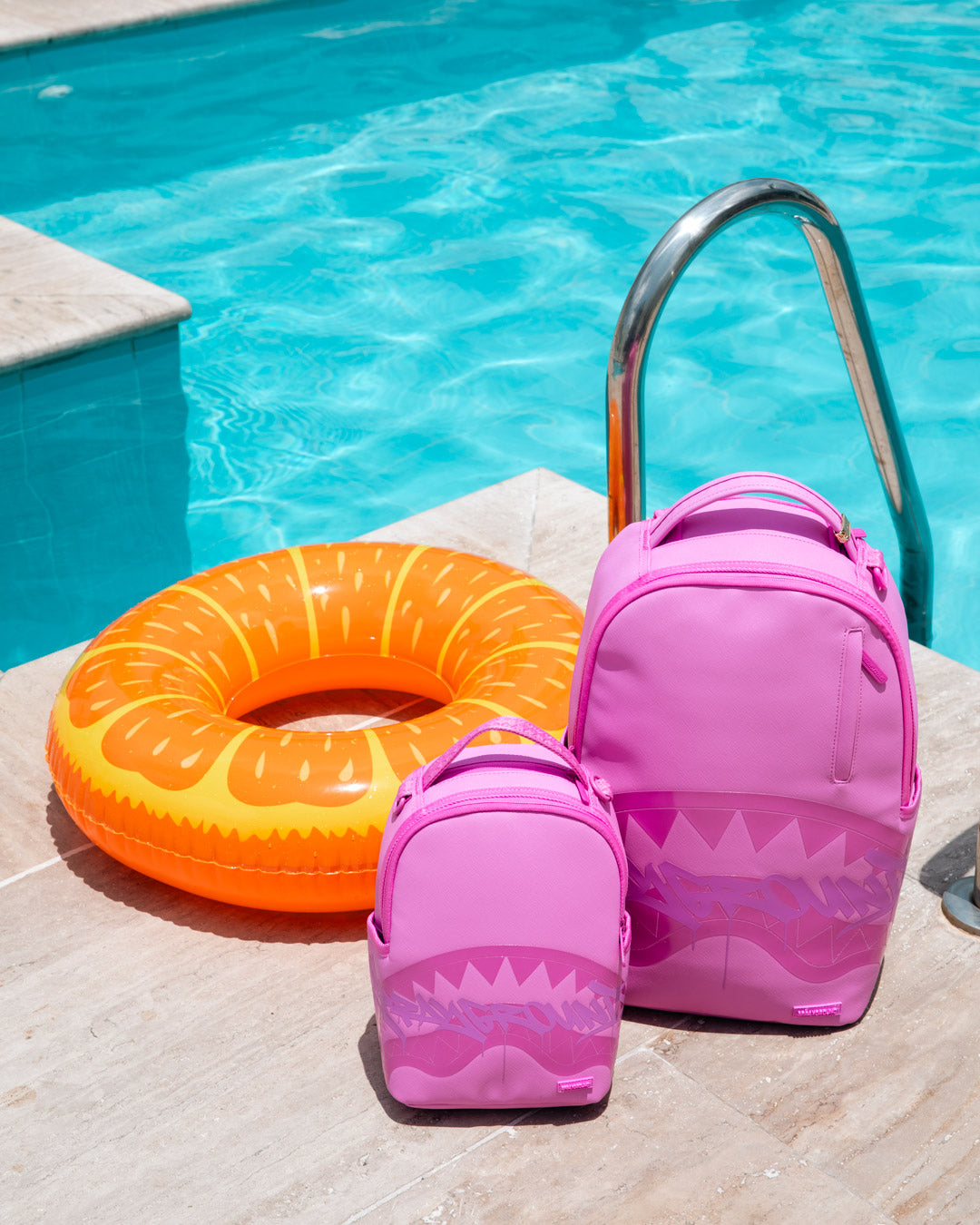 Pink shark-graphic backpack bag with matching mini bag, both with zip tops