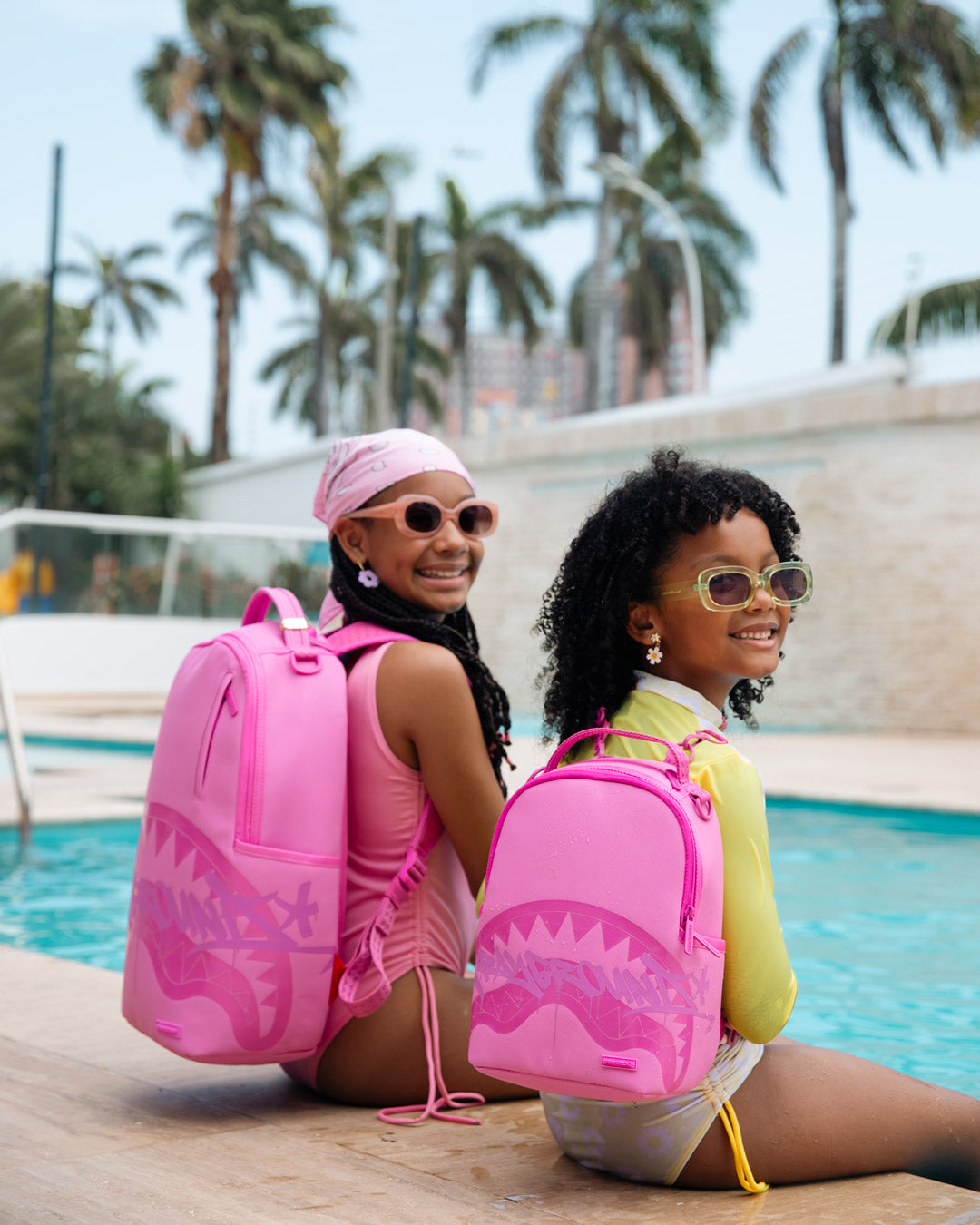 Pink shark-graphic backpack bags for kids, including a larger bag and mini bag