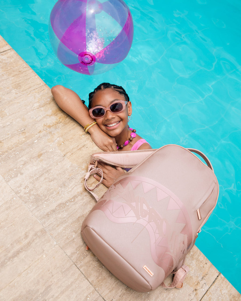 Sprayground rose backpack with shark graphic, side view on the ground