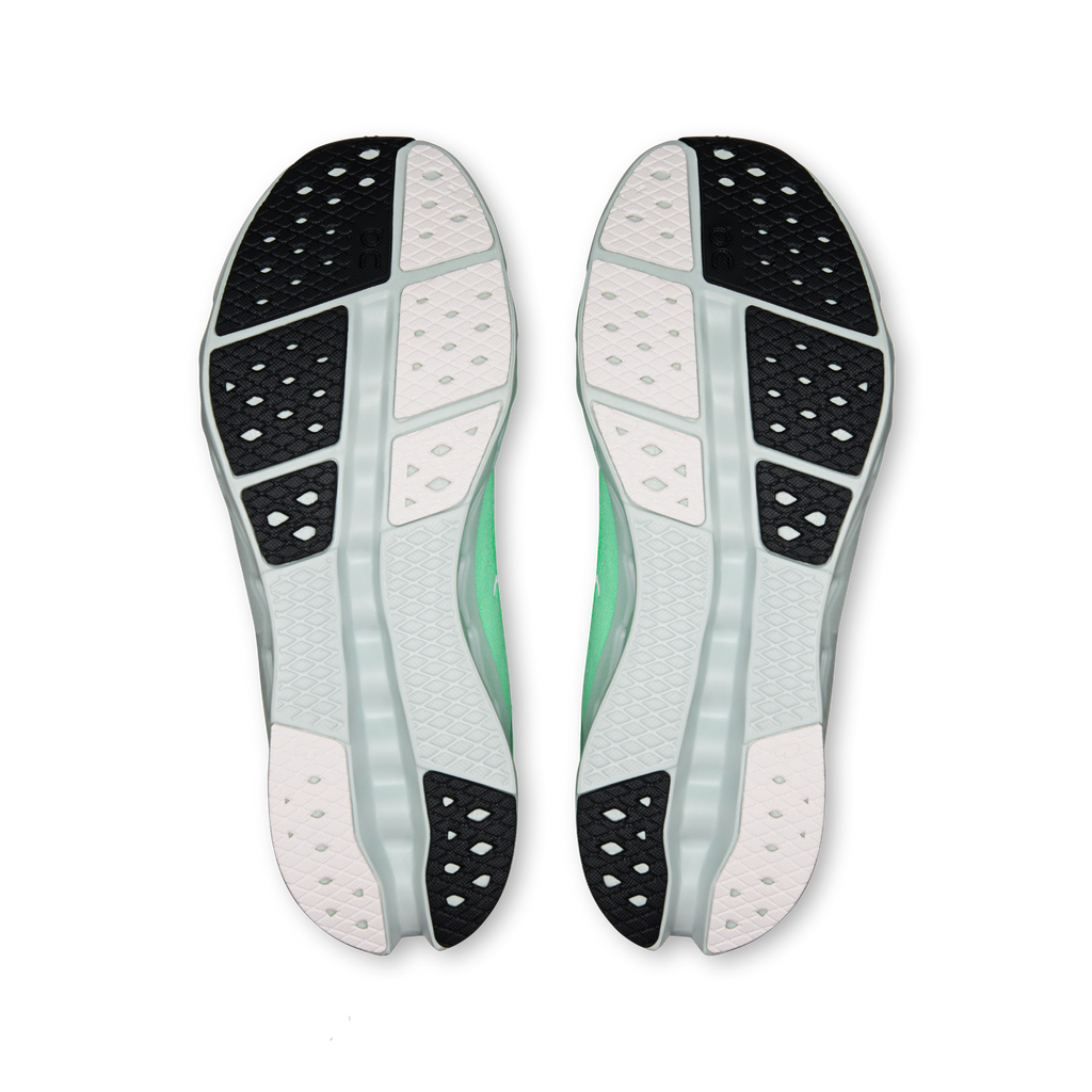 Shoe soles view: green and black tread on white outsole, pair