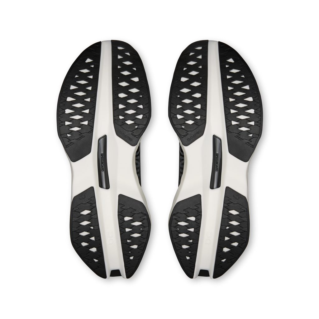 On Cloudboom Max men's shoe outsoles, black traction pods on white plates