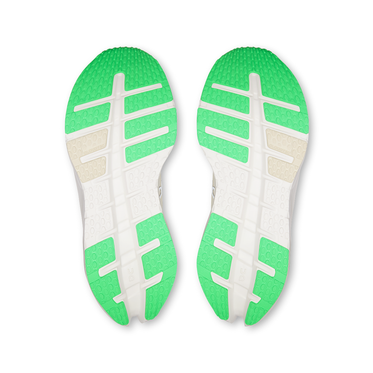 Pair of shoe outsoles with green traction pods and white crossbar tread