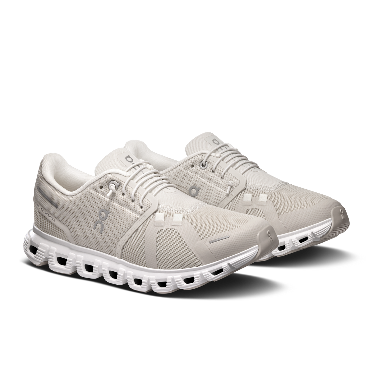 Women's pearl and white lace-up running shoes with textured upper and CloudTec pods.